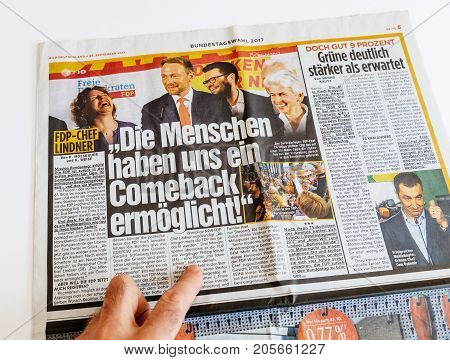 PARIS FRANCE - SEP 25 2017: Man reading German newspaper abut FDP Free Democratic Party results during Elections in 2017