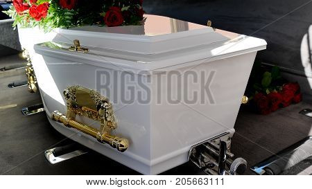 closeup shot of a colorful casket in a hearse or chapel before funeral or burial at cemetery