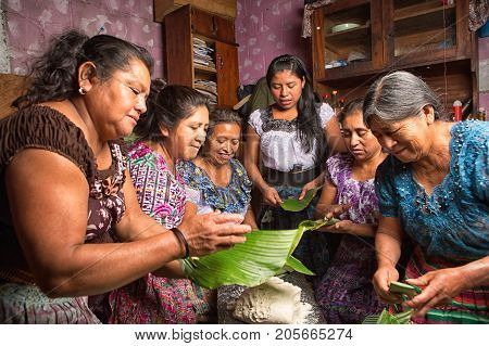 January 20, 2015 San Pedro La Laguna, Guatemala: Mayan Women In Traditional Wear Preparing Food Toge