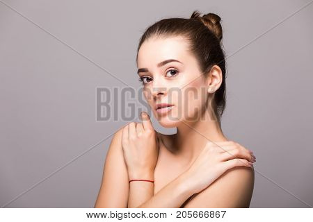 Beautiful Woman Face Close Up Hand Touching Face Studio On Gray