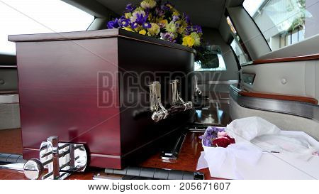 closeup shot of a colorful casket in a hearse or chapel before funeral or burial at cemetery