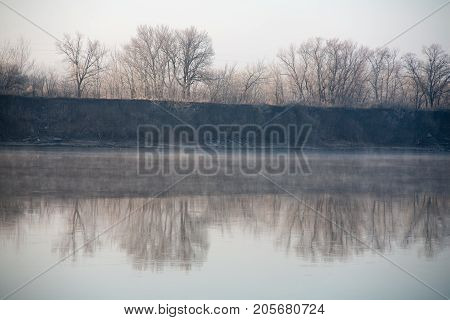 Morning on the river early morning reeds mist fog and water surface on the river
