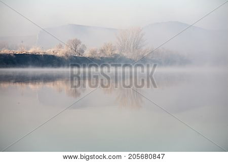 Morning on the river early morning reeds mist fog and water surface on the river
