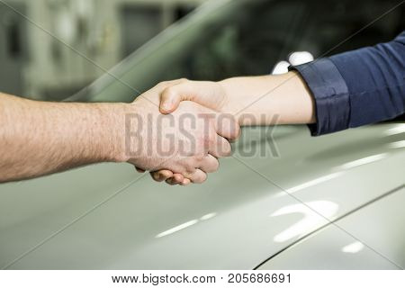 An auto mechanic and female customer in garage