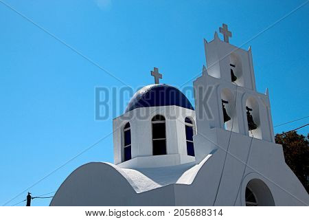 White Church with Blue dome in Fira on the Island of Santorini Greece