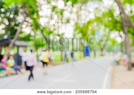 Blurred Background,people Exercise At Green Park With Bokeh Light. Healthy Lifestyle Concept