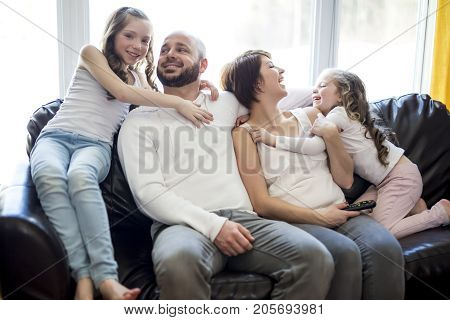 A Family sitting in living room watching tv