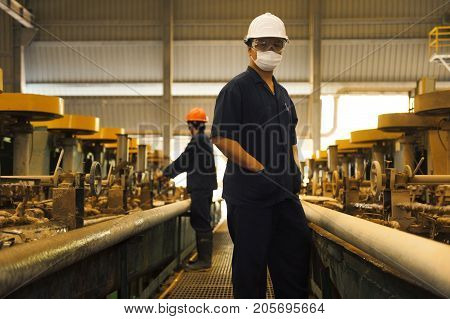 Padaeng industry Mae Sot Thailand February 20 2013: Zinc mine. Engineer walking to check machinery in factory.