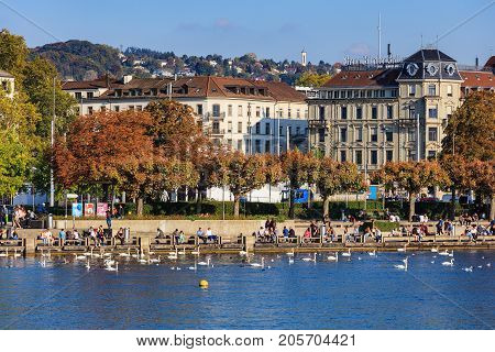 Zurich, Switzerland - 25 September, 2017: embankment of Lake Zurich in the city of Zurich in the evening, buildings of the city in the background. Lake Zurich is a lake extending southeast of the city of Zurich.