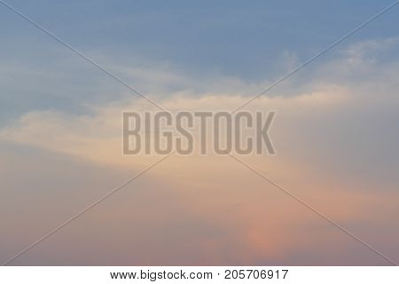 Cloudy sky in the evening light of the beautiful orange sunset.