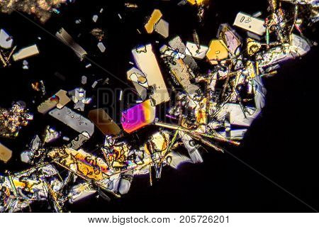microscopic shot showing colorful microcrystals in polarised light