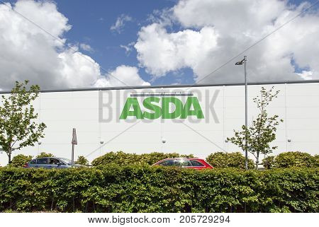 Swansea, UK: May 22, 2016: Side view of an Asda supermarket. Asda Stores Limited is an American-owned, British-founded supermarket retailer, headquartered in Leeds, West Yorkshire.