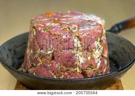 raw meat beautifully spread out in a frying pan and cooked for frying