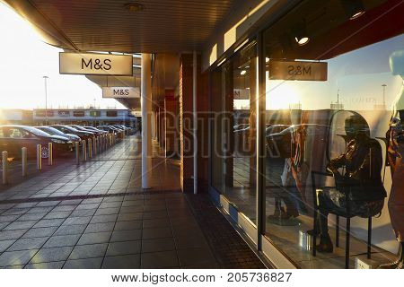 Llanelli, Wales, UK: January 25, 2016: Side view of a Marks and Spencer retail outlet in a small shopping mall. Other named retailers can be seen in the distance.
