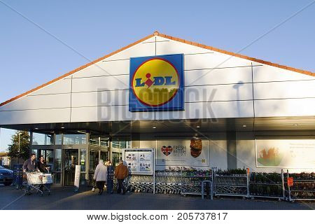 Llanelli, Wales, UK: November 07, 2016: . Lidl supermarket is a German global discount supermarket chain. shoppers are entering and leaving the store with supermarket trolley