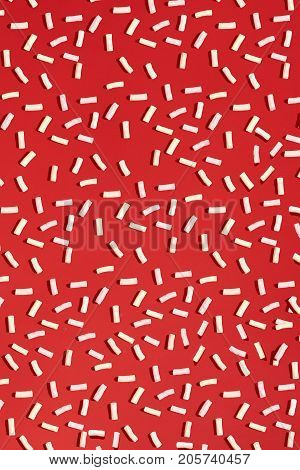 Marshmallow on a red background. Food pattern. Sweet pattern. Flat lay