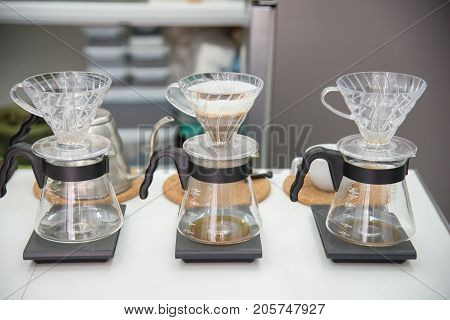 coffee drip set gadget for barista brewed arabica coffee from steaming filter on coffee table