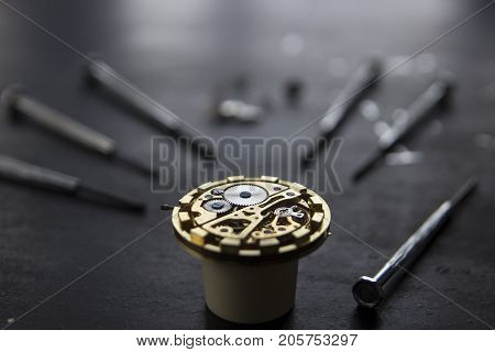 Watchmaker is repairing the mechanical watches in his workshop