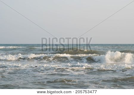 Calm tranquil blue sea with no waves and with foggy backgroudn