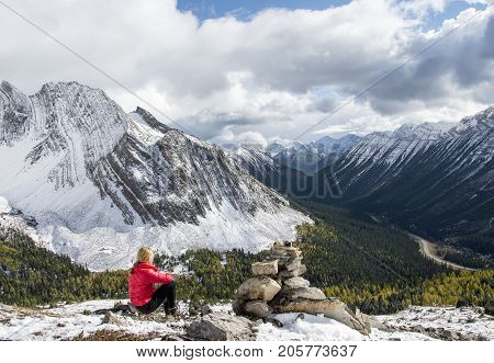 Woman resting at Arethusa Cirque in Alberta (Canada) and enjoying the mountain view.