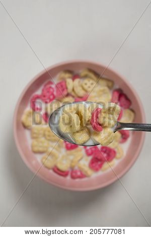 Close-up of honeycomb cereal and milk on white background