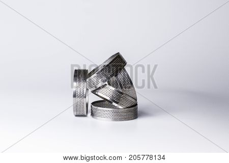 Metal perforated rings for baking tarts. Professional confectionery equipment