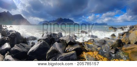 Sunny day at norway coastline. Beautiful north landscape with huge stones of norwegian sea. Panoramic view of Lofoten northern beach.