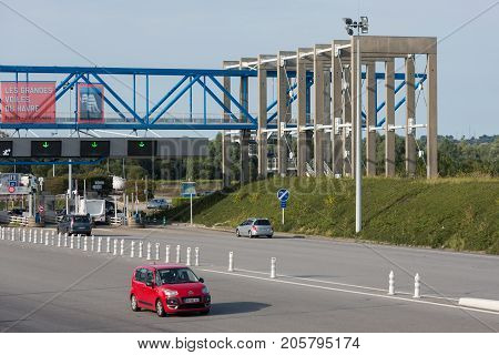 LE HAVRE FRANCE - AUGUST 24 2017: Toll station with passing cars at bridge Pont de Normandie over river Seine