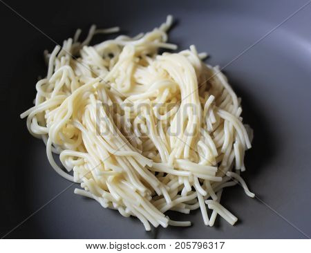 Cooked Spagetti In Grey Plate Close Up.
