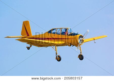 PRAGUE, CZECH REPUBLIC - 9.09.2017: One seat single engine yellow civil utility aircraft Cmelak in blue sky in Prague, Czech Republic