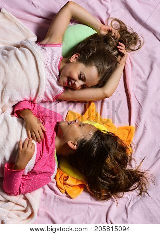 Kids With Cheerful Faces Smile At Each Other In Bed
