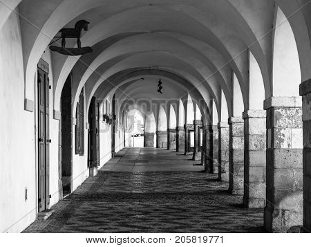 Old historical arcade in Loretanska Street near Prague Castle, Prague, Czech Republic. Black and white image