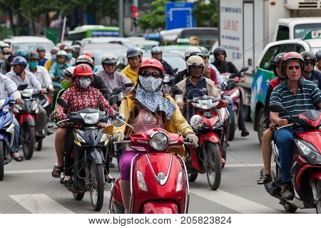 HO CHI MINH CITY (SAIGON), VIETNAM - JULY 2017 : Road traffic in Saigon, Vietnam. In the biggest city in Southern Vietnam there are more than 4 mil. motorbikes, the traffic is often congested
