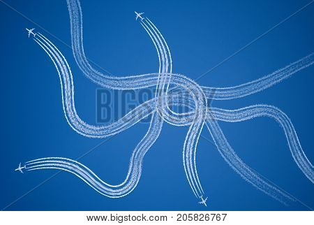 Chaotic confused stressful symbol of tangled aircraft vapor trails.