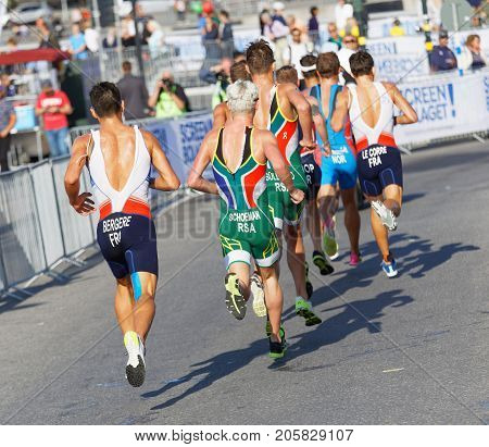 STOCKHOLM - AUG 26 2017: Back of colorful group of running triathletes Bergere Schoeman and competitors in the Men's ITU World Triathlon series event August 26 2017 in Stockholm Sweden