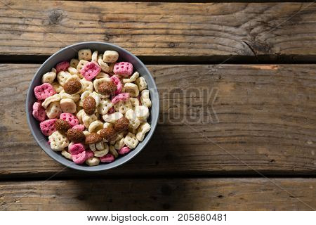 Honeycomb cereal in bowl on wooden table