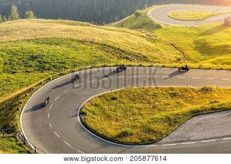 Motorcycle drivers riding in Alpine highway,  Hochalpenstrasse, Austria, Europe. Outdoor photography, mountain landscape. Travel and sport photography. Speed and freedom concept