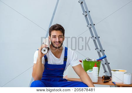 Repairman doing renovation repair in the house with paper wallpa