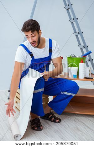 Repairman doing renovation repair in the house with paper wallpa