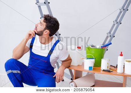 Repairman doing renovation repair in the house with paper wallpa