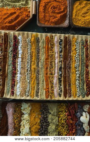 Overhead of various spices arranged in trayc
