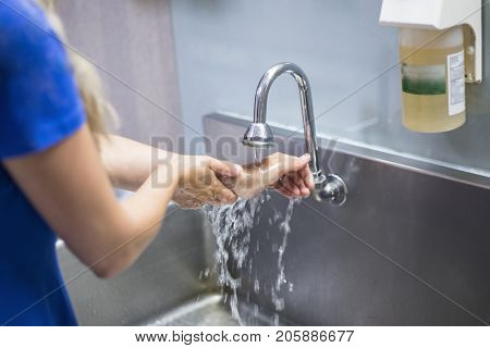 Nurse washing her hands in a hospital
