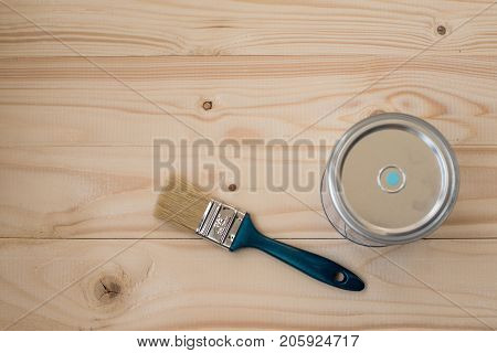 Blue paint and brush on wooden background, top view. Home improvement paint brush and opened can blue paint. Bank blue paints and brush on a wooden background. brush and paint  on a wooden background.