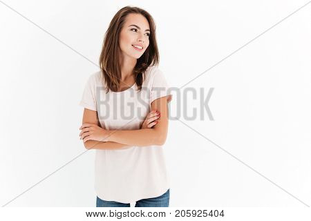 Happy woman with crossed arms looking away over white background