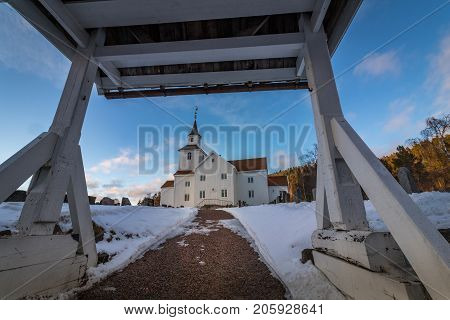 Church in march, winter landscape with snow and blue sky in Iveland in the south part of Norway