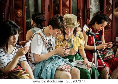 HO CHI MINH CITY (SAIGON), VIETNAM - JULY 2017 : tourists inside the central post office in neoclassical architectural style, designed and constructed by the famous architect Gustave Eiffel.