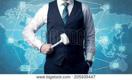 Businessman holding tool with global map graphic on the background
