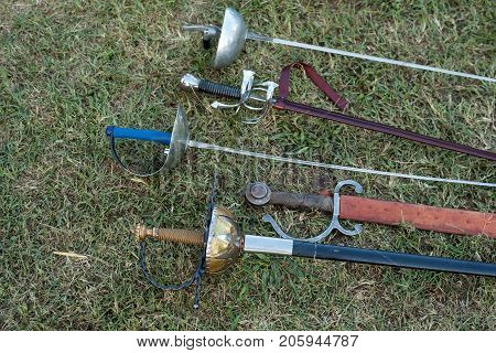 Swords and sabers on grass during the historical Reenactment in Palmanova