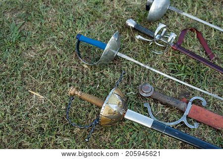 Swords and sabers on grass during the historical Reenactment in Palmanova