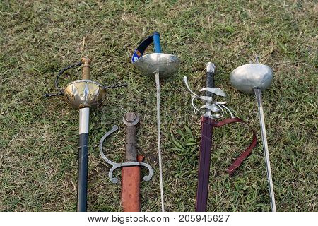 Swords and sabers on grass during the historical Reenactment in Palmanova